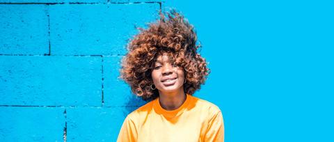 truepix blog stock adobe black woman in front of blue wall