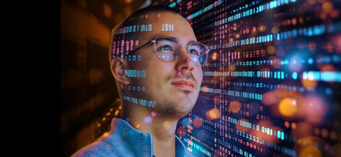 Visioneering Barco colleague, surrounded by abstract data and light sparkles. Visioneering 2.0