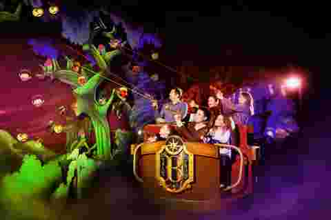 A family enjoys a dark ride Basilik powered by Barco projectors at Legendia, Poland
