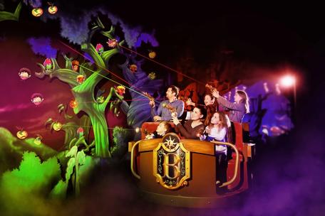 A family enjoys a dark ride Basilik powered by Barco projectors at Legendia, Poland

