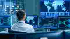 Back View in the System Control Center Operator Working. Multiple Screens Showing Technical Data. military & government