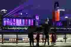 Audience looking at the projection mapping for the Pujiang lighting show on the 80,000-ton silo at Minsheng Road, Shanghai, China, with Barco UDX projectors
