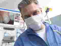 dentist looking into camera with white Eonis in background