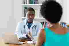 African american doctor has bad news for patient at hospital
