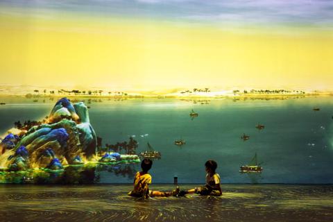 Two kids sitting in front of canvas at the Digital art exhibition A Thousand Miles of Rivers and Mountains" in Chongqing Lijia Smart Park using G60 projectors