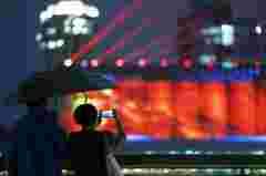 Barco working the magic on Pujiang lighting show on the 80,000-ton silo at Minsheng Road,  Shanghai, China
audience looking at projection mapping
customer story pictures