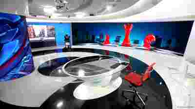 TV broadcast news studio with TruePix Smart Move campaign visual on screen