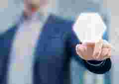 Person touching an hexagonal button on a digital interface. Concept about technology and choices