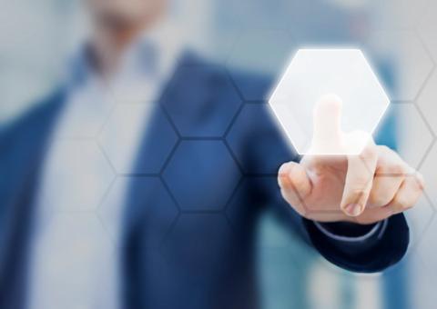 Person touching an hexagonal button on a digital interface. Concept about technology and choices