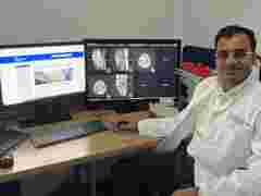 Dr Basu at his desk with a Coronis Fusion 6MP monitor