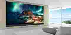 3D rendering of modern living room with TV screen and sofa on sea background."t