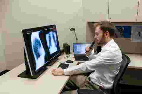 radiologist at home office desk, remote reading