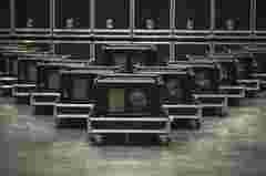 A group of UDM projectors in rental frame standing in warehouse