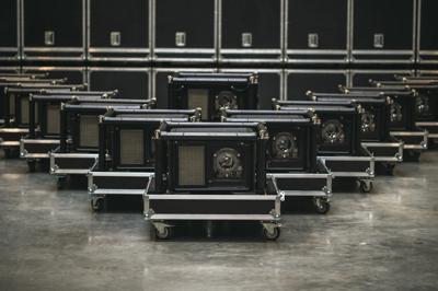 A group of UDM projectors in rental frame standing in warehouse