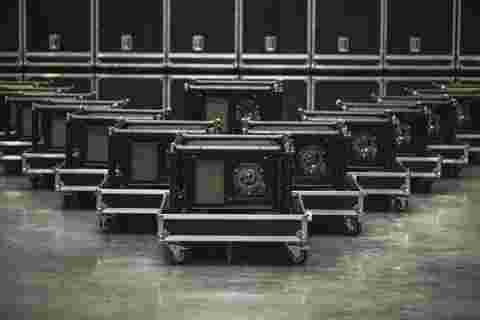 A group of UDM projectors in rental frame standing in warehouse