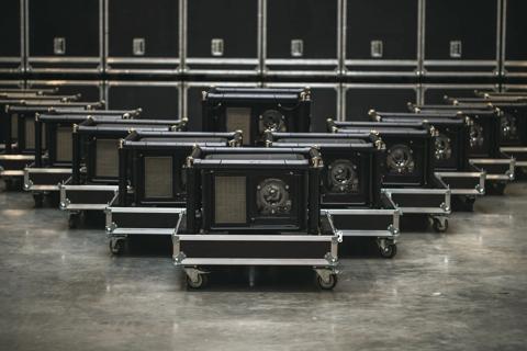 A group of UDM projectors in rental frame standing in warehouse