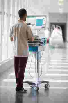 Eonis display on trolley, being pushed in a hospital hallway