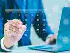 Businessman making red circles on important days on the calendar Important appointment dates, reminders or schedules for meetings or tasks, deadlines or planning appointments for efficient work time.