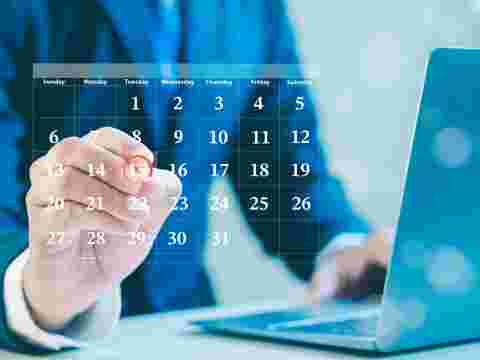 Businessman making red circles on important days on the calendar Important appointment dates, reminders or schedules for meetings or tasks, deadlines or planning appointments for efficient work time.
