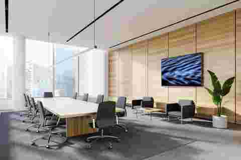 Corner of panoramic meeting room with white and wooden walls, concrete floor, long conference table and lounge area with TV and armchairs. Blurry cityscape. 3d rendering
