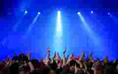 audience on a rock concert raising hands