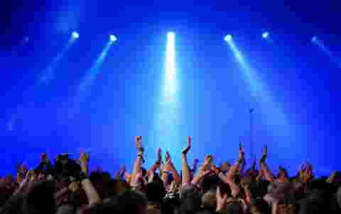 audience on a rock concert raising hands