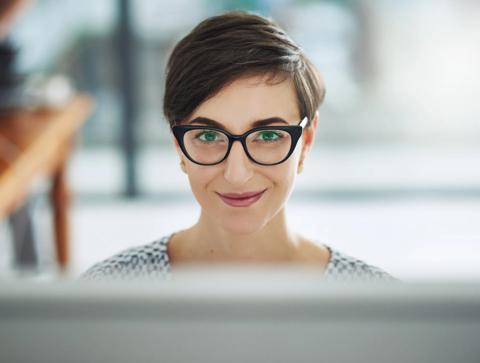 Portrait of a young businesswoman working on a computer in an office