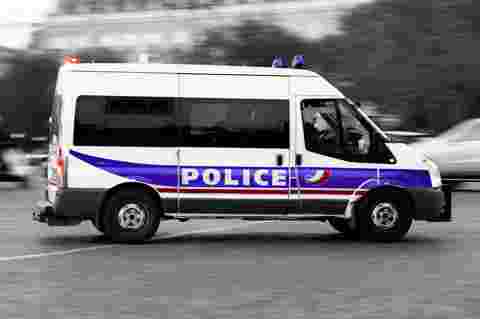 French police customer story vehicle driving through streets in action