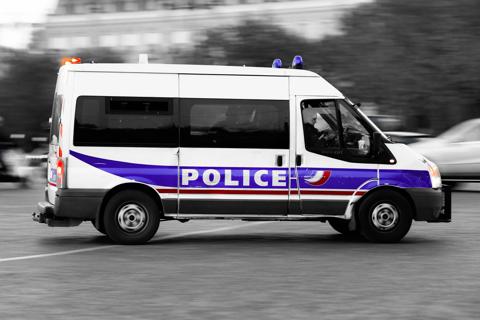 French police customer story vehicle driving through streets in action