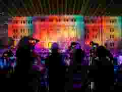 Audience looking at projection mapping show on Shanghai concert hall with Barco UDX projectors