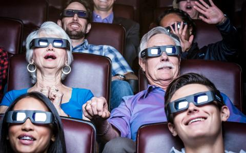 cinemagoers enjoying a movie and showing various emotions