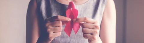 woman holding pink ribbon, breast cancer awareness, October pink concept