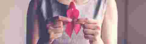 woman holding pink ribbon, breast cancer awareness, October pink concept